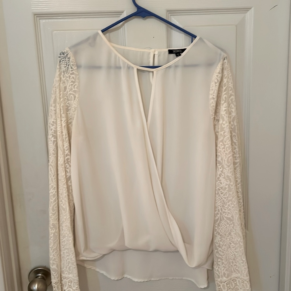 Graceful white blouse with lace sleeves